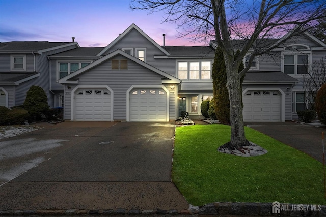 view of front of home featuring a garage, driveway, and a front lawn