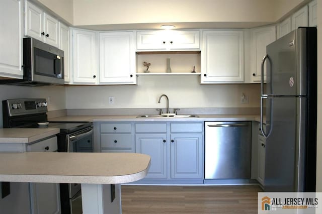 100 John T O Leary Blvd Unit 311, South Amboy, NJ 08879 - kitchen with appliances with stainless steel finishes, a sink, white cabinets, light countertops, and wood finished floors