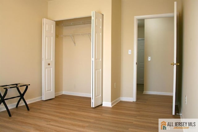 100 John T O Leary Blvd Unit 311, South Amboy, NJ 08879 - unfurnished bedroom with light wood-style flooring, baseboards, and a closet
