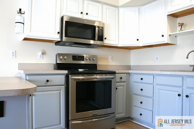100 John T O Leary Blvd Unit 311, South Amboy, NJ 08879 - kitchen featuring stainless steel appliances, a sink, light countertops, white cabinets, and open shelves