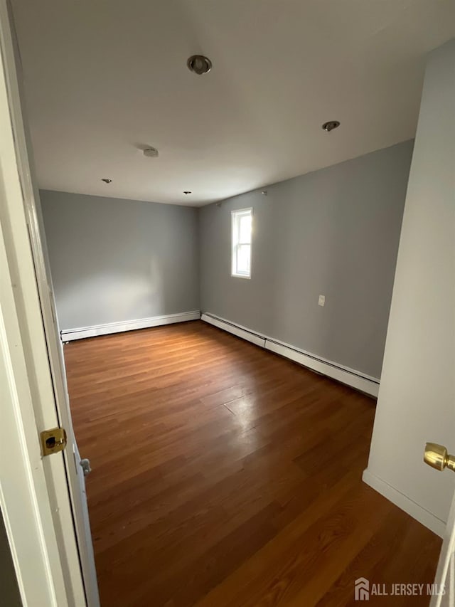 79 W 18th St, Bayonne, NJ 07002 - unfurnished room with a baseboard radiator, dark wood-style flooring, and recessed lighting