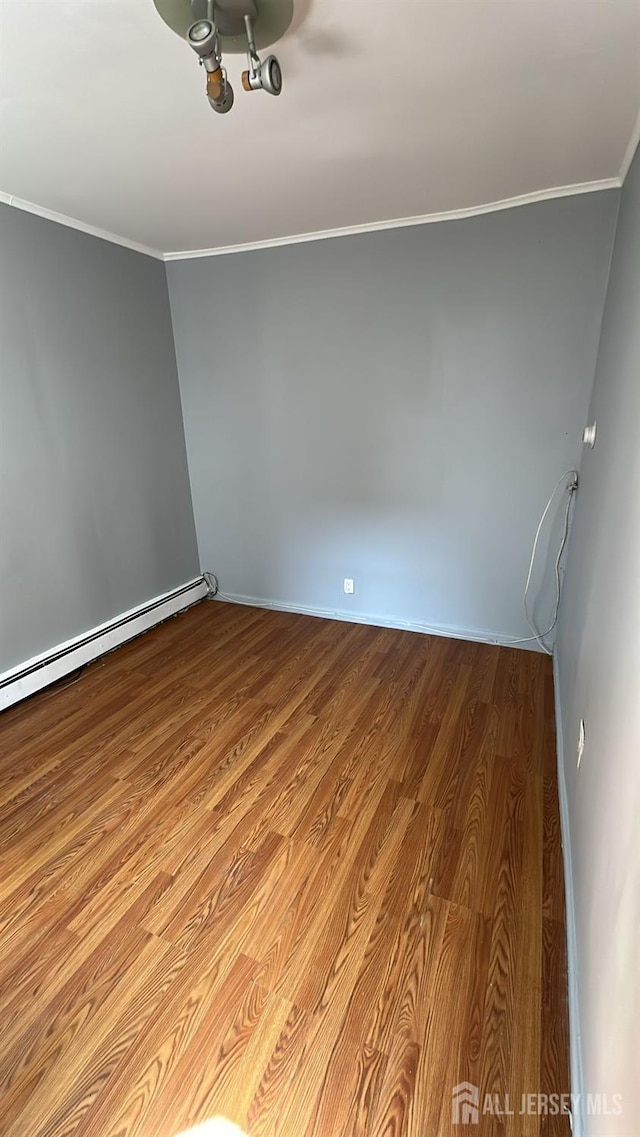 79 W 18th St, Bayonne, NJ 07002 - unfurnished room with crown molding, wood finished floors, and baseboard heating
