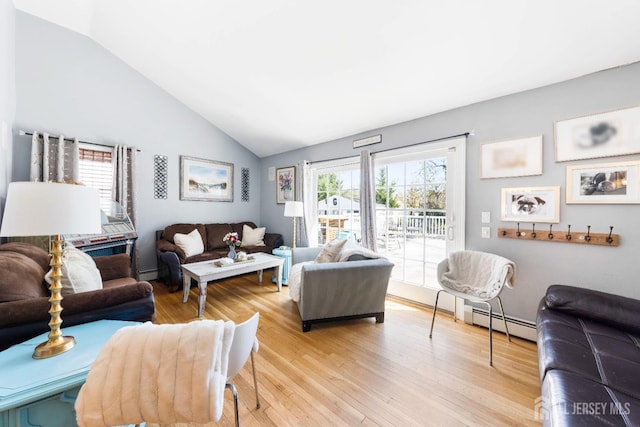 living room featuring a baseboard radiator, light wood-style flooring, lofted ceiling, and baseboard heating