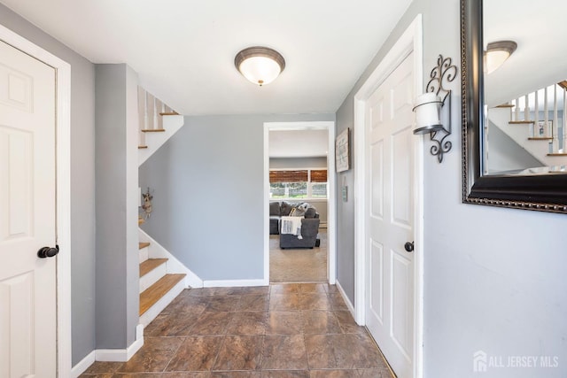 interior space with stairs and baseboards