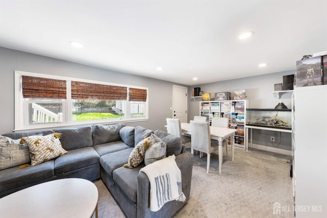 living area featuring recessed lighting and light colored carpet