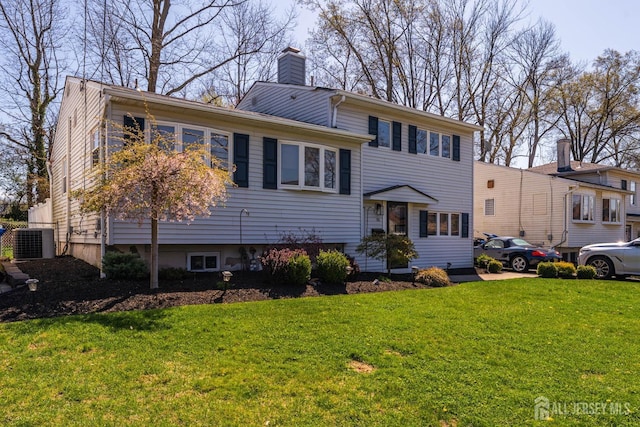 tri-level home with a front lawn, central AC, and a chimney