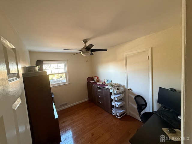 office space with ceiling fan and dark hardwood / wood-style flooring