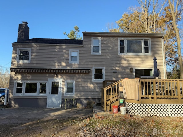 back of property featuring a wooden deck