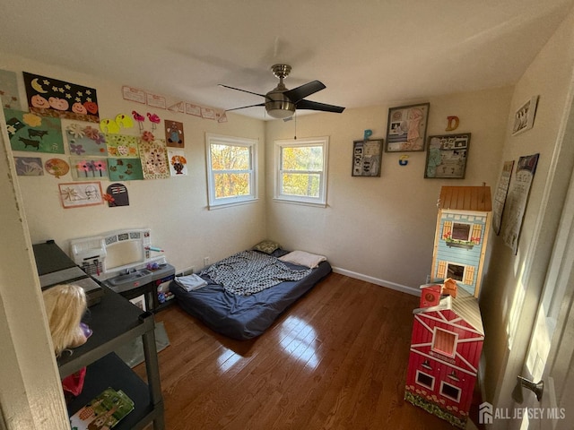 bedroom with ceiling fan and hardwood / wood-style flooring