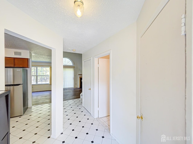 corridor with a textured ceiling