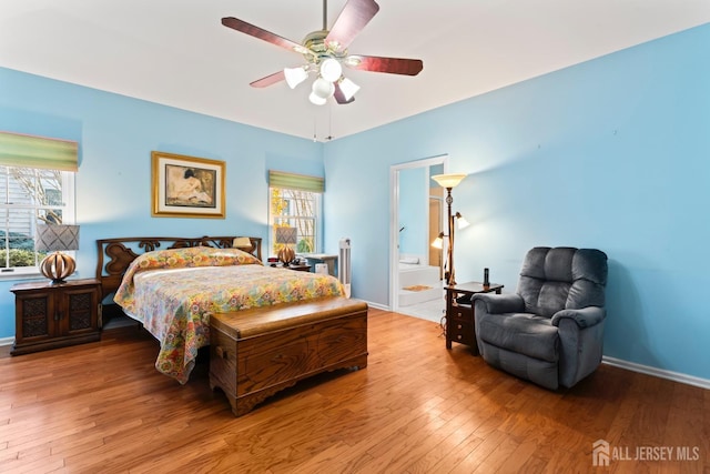 bedroom with wood-type flooring, multiple windows, ceiling fan, and baseboards