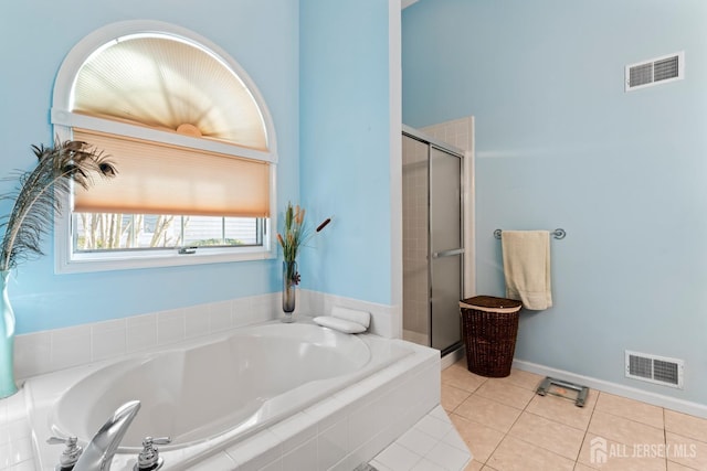 full bathroom featuring visible vents, a shower stall, a bath, and tile patterned floors