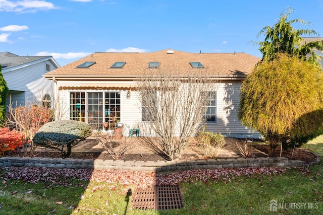 rear view of property featuring roof with shingles