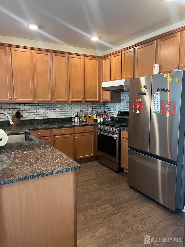1425 Hudson Cir, Highland Park, NJ 08904 - kitchen featuring appliances with stainless steel finishes, a sink, dark wood-type flooring, brown cabinetry, and under cabinet range hood