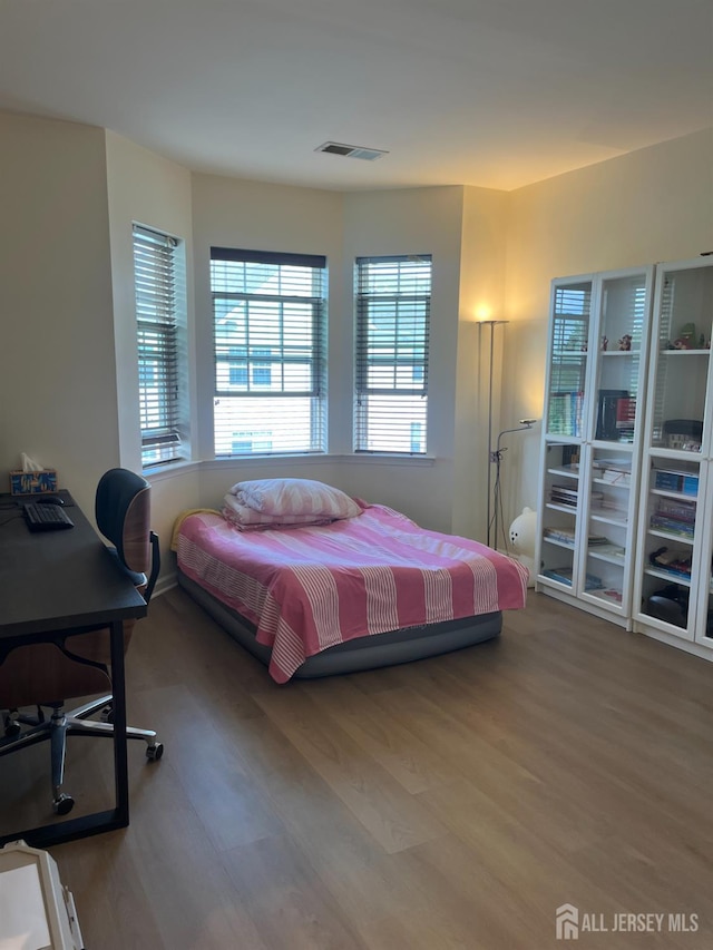 1425 Hudson Cir, Highland Park, NJ 08904 - bedroom with wood finished floors and an office area