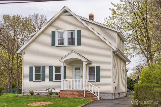 55 Leland Ave, Plainfield, NJ 07062 - view of front of home featuring a chimney and a front lawn