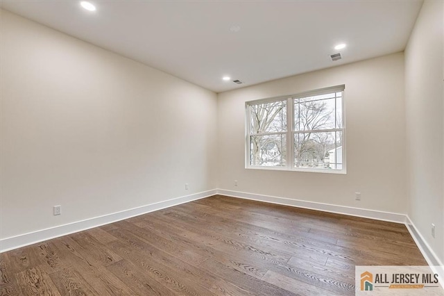 unfurnished room featuring hardwood / wood-style flooring