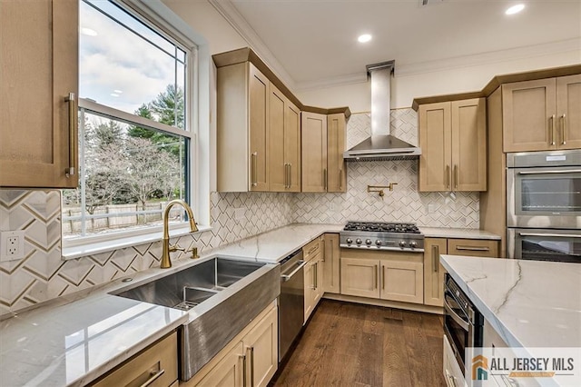 kitchen with appliances with stainless steel finishes, light stone countertops, wall chimney range hood, crown molding, and dark hardwood / wood-style floors