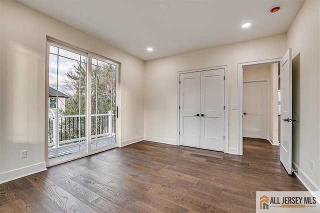 empty room with dark hardwood / wood-style floors