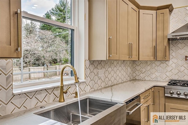 kitchen featuring a wealth of natural light, sink, backsplash, and stainless steel gas stovetop