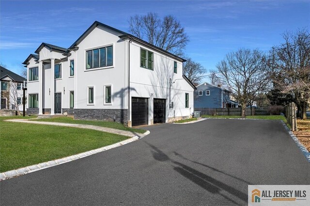 exterior space featuring a lawn and a garage