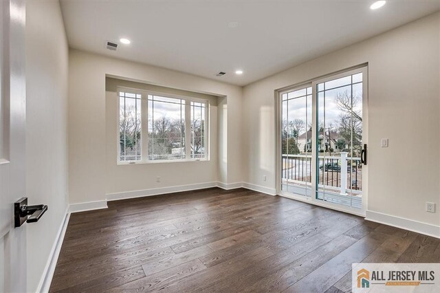 interior space with plenty of natural light and dark wood-type flooring