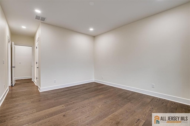 unfurnished room with dark hardwood / wood-style flooring