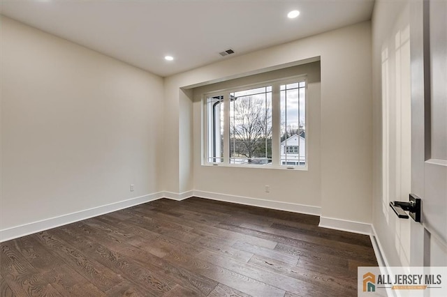 spare room featuring dark hardwood / wood-style flooring