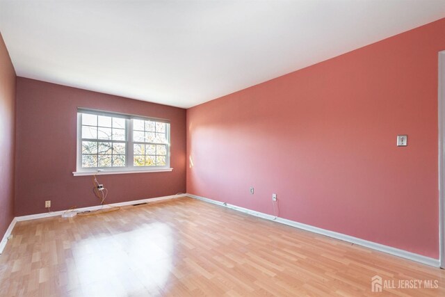 unfurnished room with light hardwood / wood-style floors