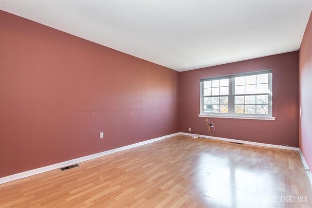 unfurnished room featuring light hardwood / wood-style floors