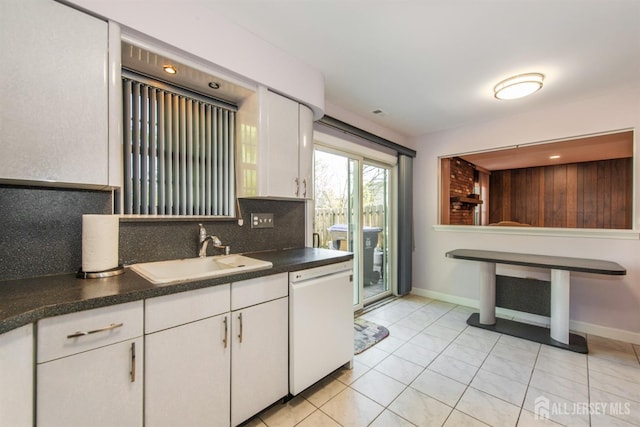 kitchen with dishwasher, sink, white cabinets, tasteful backsplash, and light tile patterned flooring