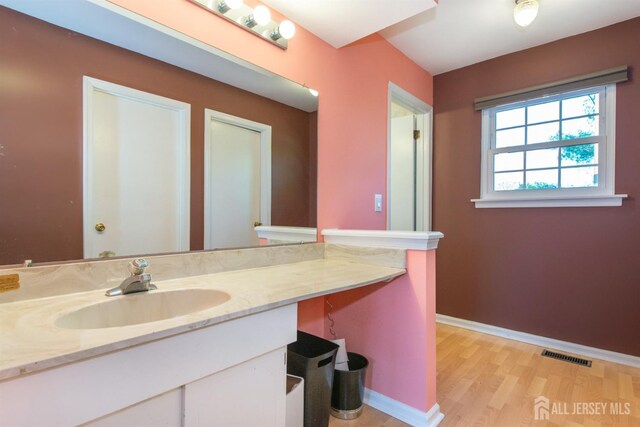 bathroom with hardwood / wood-style flooring and vanity