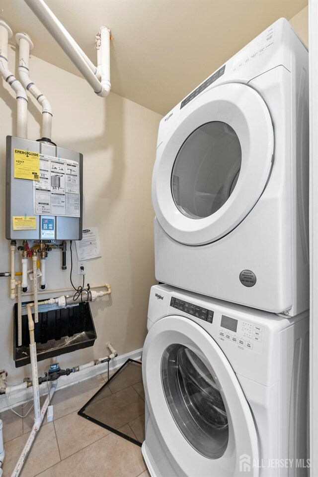1305 Parker Blvd, West Windsor, NJ 08550 - washroom featuring stacked washer / drying machine, water heater, and tile patterned floors