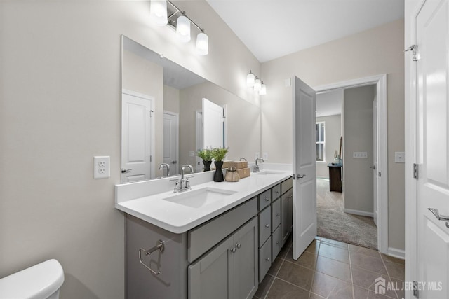1305 Parker Blvd, West Windsor, NJ 08550 - full bath with tile patterned floors, toilet, double vanity, and baseboards