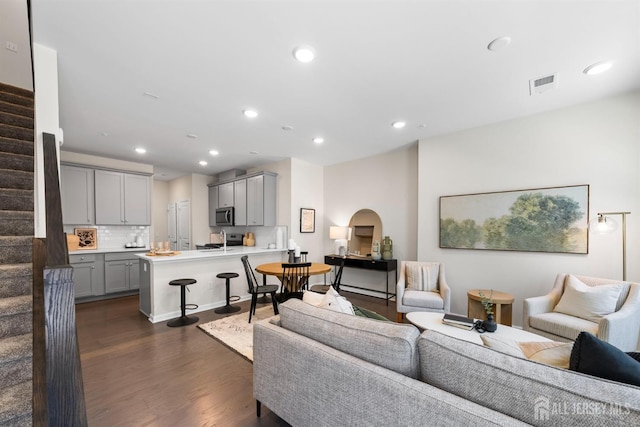 1305 Parker Blvd, West Windsor, NJ 08550 - living area featuring stairs, dark wood finished floors, recessed lighting, and arched walkways