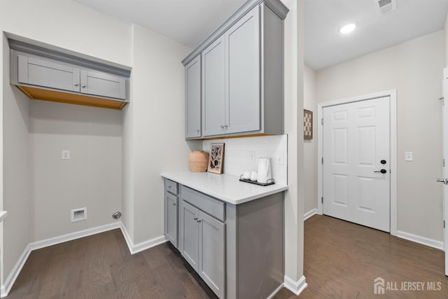 1305 Parker Blvd, West Windsor, NJ 08550 - laundry area featuring dark wood-style flooring, baseboards, cabinet space, and recessed lighting