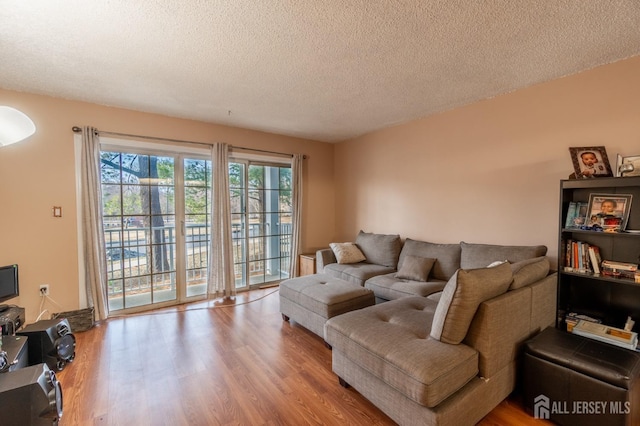 living area featuring a textured ceiling and wood finished floors