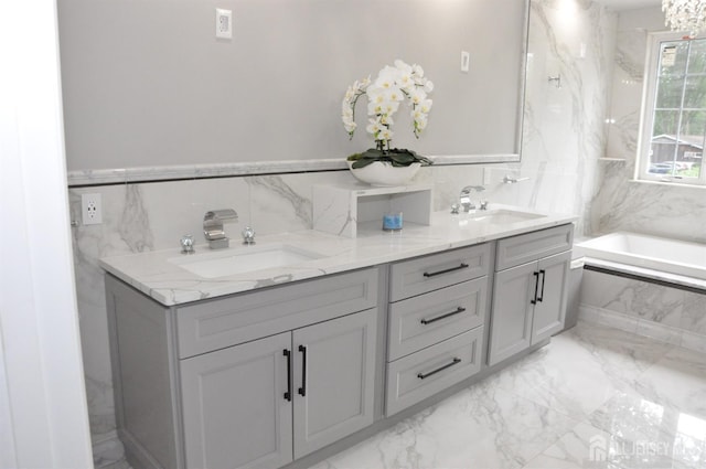 260 Church Ln, North Brunswick, NJ 08902 - bathroom featuring marble finish flooring, a tub with marble appearance, tile walls, and double vanity