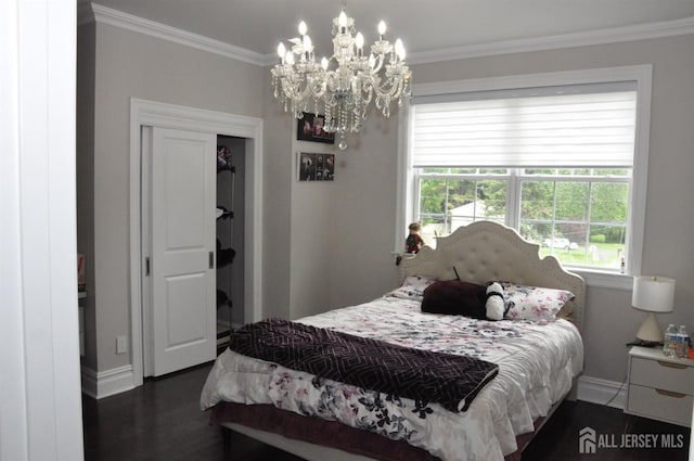 260 Church Ln, North Brunswick, NJ 08902 - bedroom with baseboards, ornamental molding, a chandelier, dark wood-style flooring, and a closet