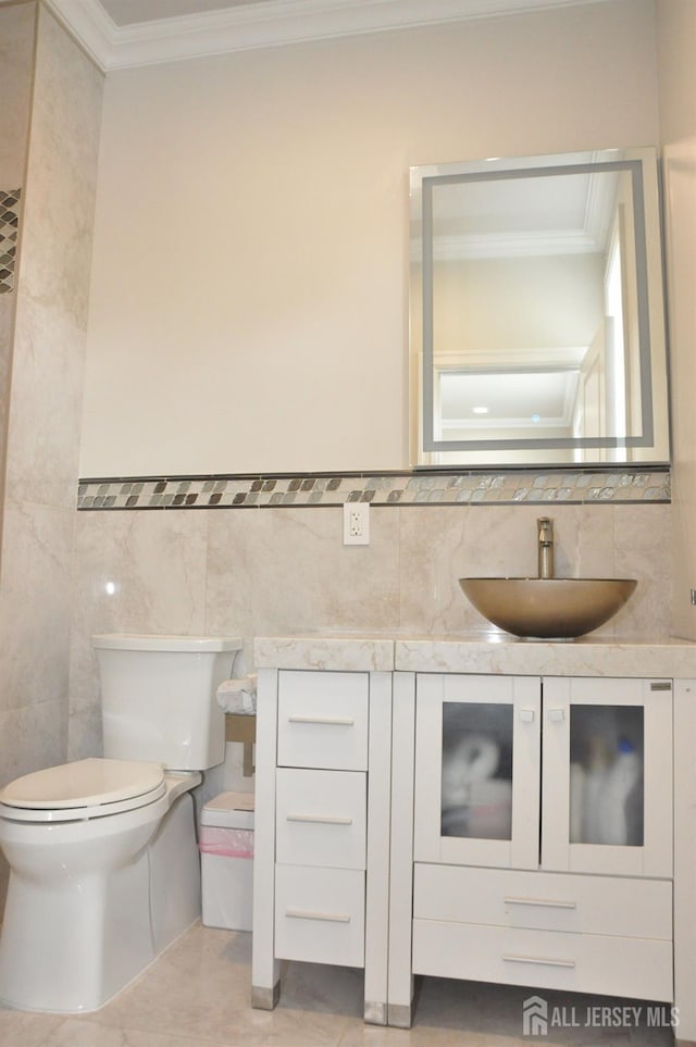 260 Church Ln, North Brunswick, NJ 08902 - bathroom featuring crown molding, tile walls, toilet, and vanity
