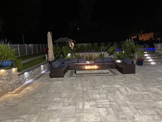 260 Church Ln, North Brunswick, NJ 08902 - patio at twilight featuring an outdoor living space with a fire pit and a patio area