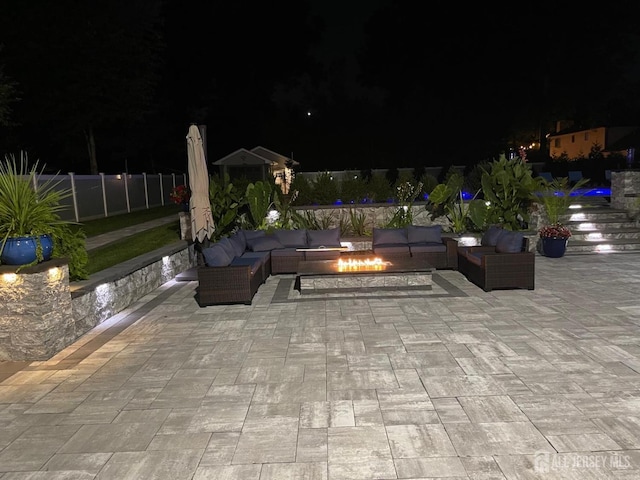 260 Church Ln, North Brunswick, NJ 08902 - patio at twilight featuring an outdoor living space with a fire pit and a patio area