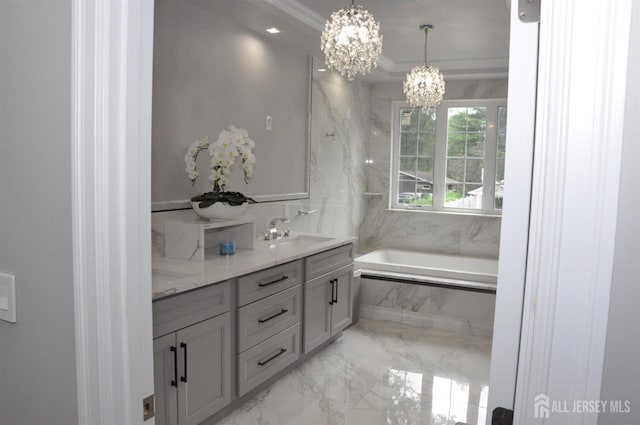 260 Church Ln, North Brunswick, NJ 08902 - full bathroom featuring a chandelier, marble tiled floors, a garden tub, vanity, and ornamental molding