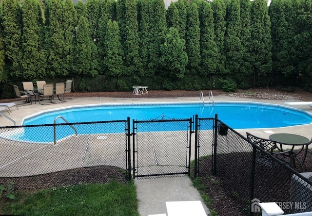 415 Spotswood Englishtown Rd, Monroe, NJ 08831 - community pool with a diving board, a gate, fence, and a patio