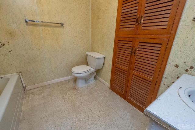 bathroom featuring vanity, toilet, and a bathing tub