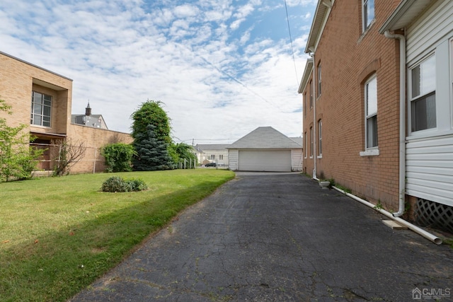 view of yard featuring a garage and an outdoor structure