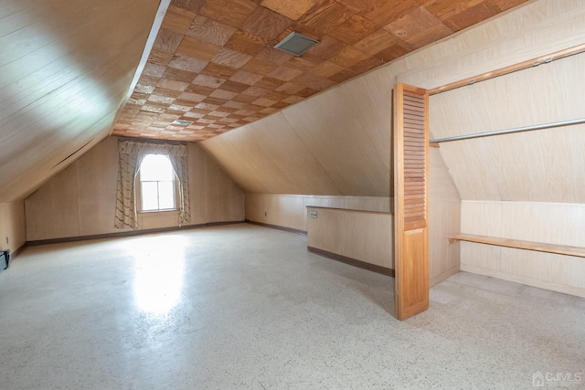 bonus room featuring wooden ceiling, wooden walls, and vaulted ceiling