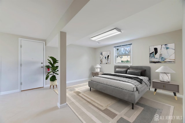 bedroom with baseboards and light colored carpet