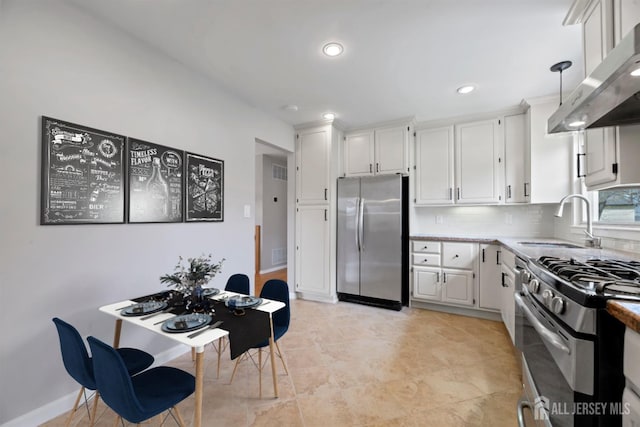 kitchen featuring a sink, light countertops, white cabinets, stainless steel appliances, and extractor fan
