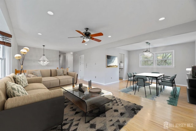living room featuring baseboards, recessed lighting, light wood-style floors, and ceiling fan